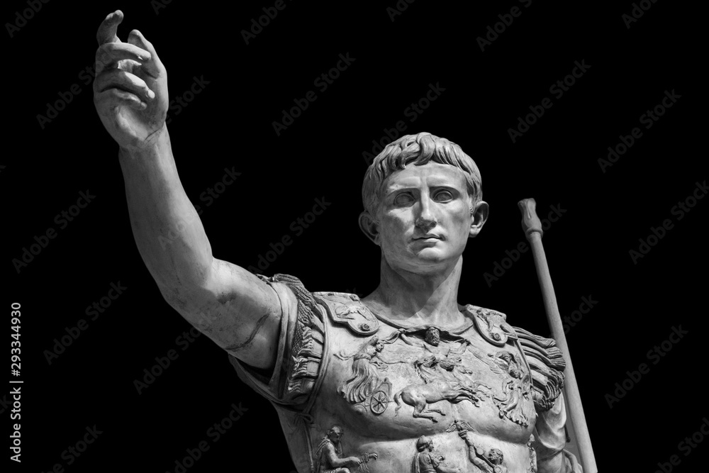 Caesar Augustus, the first emperor of Ancient Rome. Bronze monumental statue in the center of Rome isolated on black background - obrazy, fototapety, plakaty 