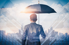 The Double Exposure Image Of The Businessmen Are Spreading Umbrella During Sunrise Overlay With Cityscape Image. The Concept Of Modern Life, Business, Insurance And Protection.