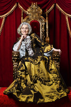 Portrait Of Beautiful Senior Queen On Throne