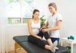© Louis-Paul Photo - A Modern rehabilitation physiotherapist at work with client. working on knee