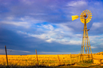 saline county, ks usa - aermotor windmill in the prairie at sunset