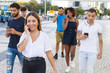 © Mangostar - Happy excited woman talking on cell while walking down city street. Mix raced men and women going outside, talking on cells, using mobile phones. Smartphone using concept