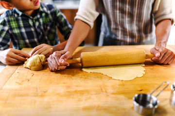 Wall Mural - Mother and son baking together. American family. Single mother. Child helping mother.