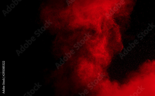 Red color powder explosion on black background.Freeze motion of red dust part...