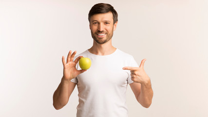 Poster - Man Pointing Finger At Apple In Hand, White Background, Panorama