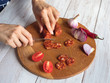 © sablinstanislav - Chorizo sausage is sliced on a wooden chopping board.