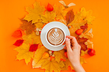 Wall Mural - Coffee latte cup in dry autumn leaves wreath frame