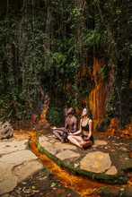 Couple Meditating At Waterfall