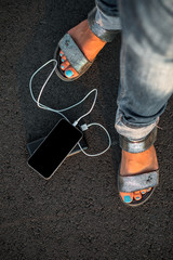 woman hands holding black smartphone charging battery from external power bank