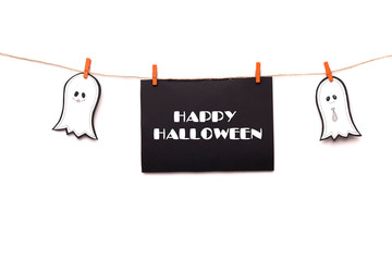 Happy halloween text hanging on the rope with two ghosts