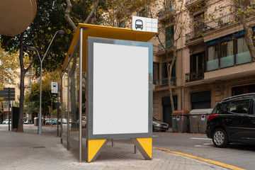 Wall Mural - Blank canvas white outdoor banner at bus stop next to facade of ancient building at european town.
