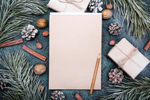 Christmas Background With Blank Notebook Surrounded By Christmas Decorations. Letter To Santa Or Christmas Shopping List