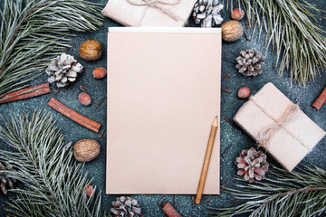 Christmas background with blank notebook surrounded by Christmas decorations. Letter to Santa or Christmas shopping list