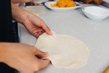 Close up hands while doing roll out doughs for patty,pastry and raviaoli