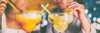 © Maridav - Nightlife party drinks people dating on night out drinking giant margarita and mojito cocktails party couple going out at Miami Ocean drive bar banner panoramic header background.