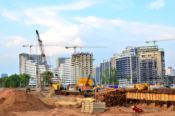 Poster - Huge construction site with a lot of construction equipment, houses under construction, tower cranes and workers. Piles driven into the ground by hydraulic hammering. Subway construction project