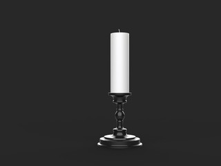 White wax candle on a black candle holder