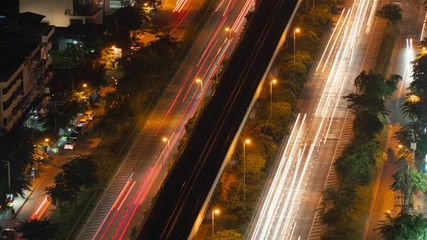 Aufkleber - Time lapse of cars driving on highway or freeway with light speed. Bridge roads or streets in structure of architecture and transportation concept. Top view. Urban city, Bangkok at night, Thailand.