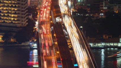Aufkleber - Time lapse of cars driving on highway or freeway with light speed. Bridge roads or streets in structure of architecture and transportation concept. Top view. Urban city, Bangkok at night, Thailand.