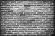 © peekeedee - old dark brick wall cracked concrete vintage background
