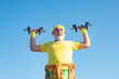 © Volodymyr - Old man holding his hands in front of him while lifting dumbbells. Grandfather exercising with dumbbell. Sport for senior man.