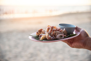 Wall Mural - Grilled squid plate on beach sea