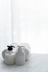 Liquid soap and shampoo bottle in bedroom. Hygiene and healthy life concept.