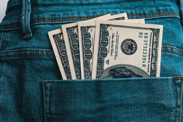 A hundred American bills in cash in the back pocket of his jeans.