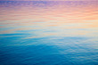© Alwih - Clear water texture in blue and orange. Background of the ocean and the sea backlit by the sun. Soft waves. Natural water