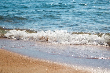 sandy beach and blue sea wave. Beautiful natural background. Tourism and travel.