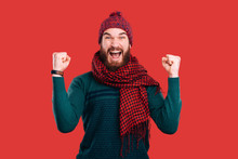 Cheerful And Excited Young Man With Beard Celebrate Success Over Red Background