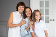 © stock28studio - Daughter, mother and grandmother stand closeto each other and hugging