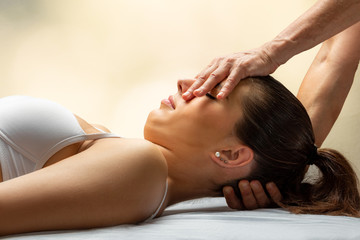 Wall Mural - Osteopath doing neck and head manipulation on female patient.