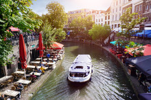 Canal Oudegracht With Boat And Sidewalk Cafes In Downtown Utrecht, Netherlands