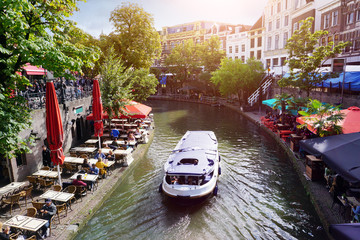 Canal Oudegracht with boat and sidewalk cafes in downtown Utrecht, Netherlands