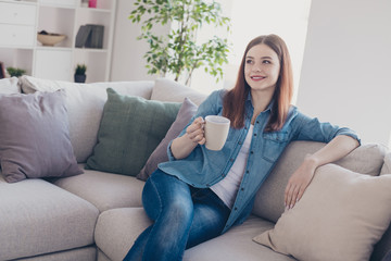 Sticker - Photo of pretty lady holding hot beverage in hand dreamy remembering romance date sitting comfy on sofa wearing jeans clothes homey in apartment