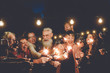 © Alessandro Biascioli - Happy family having at dinner party outdoor - Group of multiracial older and young people celebrating together drinking wine holding fireworks sparklers - Concept of youth and elderly parenthood