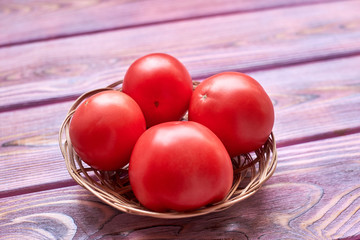 Poster - Fresh tomatoes on a pink wooden background.