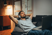 Man Listening Music At His Home Relaxed On Sofa