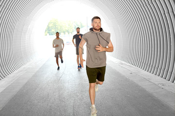 Wall Mural - fitness, sport and healthy lifestyle concept - young men or male friends running outdoors