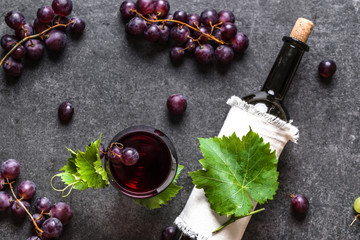 Wall Mural - Red wine glass, fresh grape fruits and wine bottle, top view