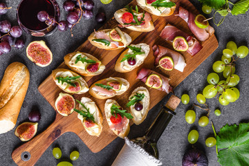 Traditional tapas bar, spanish table with food, platter with appetizers or italian bruschetta with cheese and meat. Wine snack set