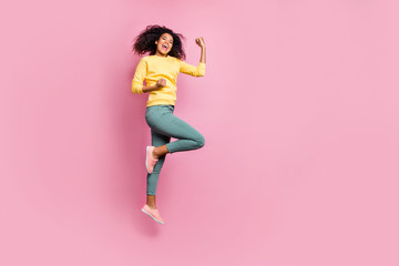 Wall Mural - Full body photo of emotional enthusiastic cheerful expressing triumph having nice mood hipster jumping up waiting for prize wear yellow sweater pants isolated pastel color background
