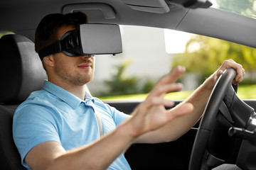 Wall Mural - virtual reality, technology and driving concept - man or driver wearing vr glasses in car