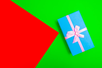 Poster - gift box with ribbon on a colorful background. view from above.
