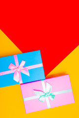 Sticker - colored boxes with ribbons on a colorful background. view from above.