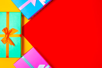 Poster - colored boxes with ribbons on a colorful background. view from above.