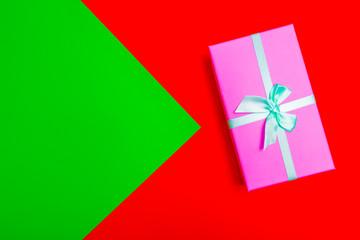 Poster - gift box with ribbon on a colorful background. view from above.
