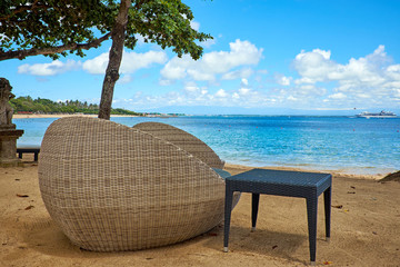 Wall Mural - Tropical beach panorama with deckchairs, umbrellas, boats and palm tree