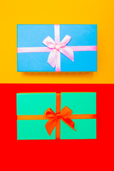 Poster - colored boxes with ribbons on a colorful background. view from above.